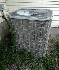 The dirt and debris on and around this AC condenser reduces the AC’s ability to cool your home.